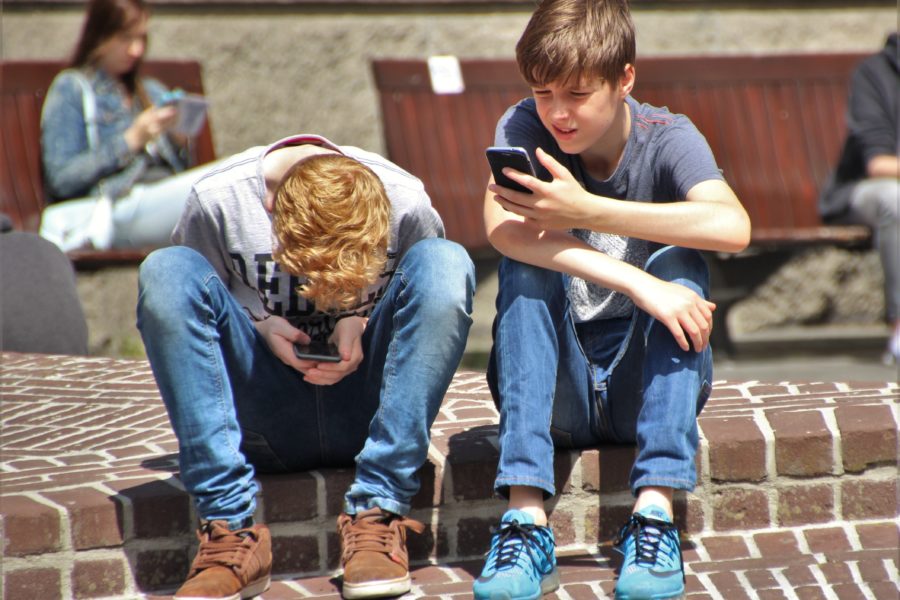 Teenage boys on cell phones